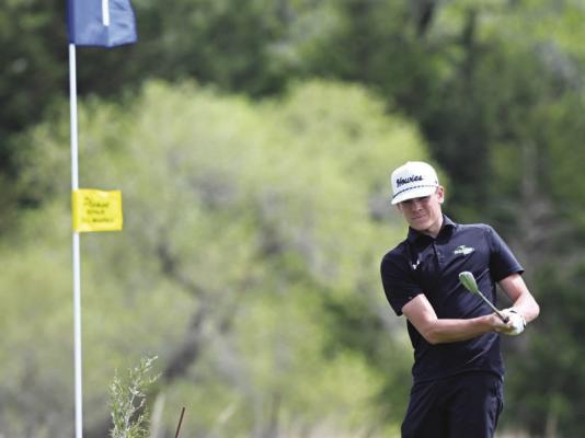 CENTRAL CITY’S KARTER NEGUS chips on to the second green at the St. Paul Country Club on Thursday afternoon during his round at the Wildcats’ annual invite. Negus finished the day shooting two strokes under par and placed second. Photos by Michael Happ