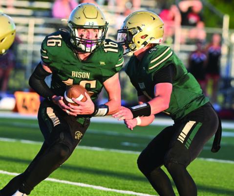NATE BANDT takes a hand off from quarterback Quinn Jensen in Central City’s 41-7 Homecoming win over Douglas County West. Photos by Michael Happ