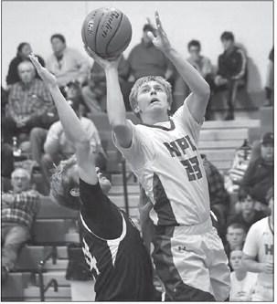 BRODEY SPURLING drives to the basket and makes a difficult shot in High Plains’ game with Grand Island Lutheran.