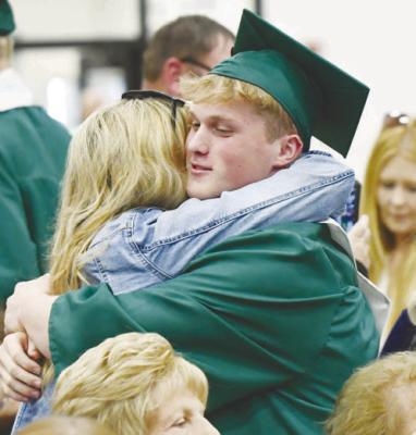 BLAKE BURBACH embraces a loved one during Sunday afternoon’s commencement exercises at Central City High School. Sixty-six students graduated during the event. Photos by Jordan Coslor