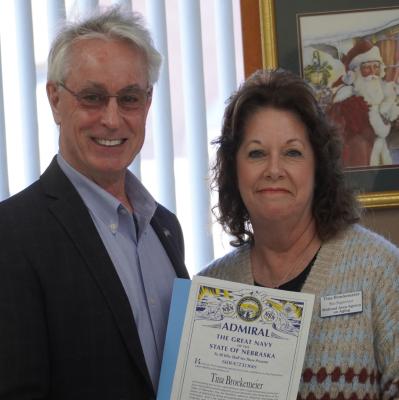 Admiring Hard Work Nebraska State Senator Loren Lippincott presents Tina Broekemier with the prestigious Nebraska Admiralship Award on Monday morning.