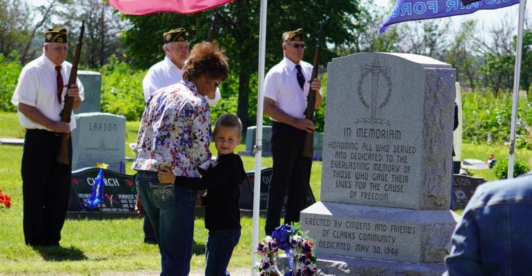 Memorial Day in Clarks During the service Rita and Micah Zoucha placed a wreath while the color guard looked on.