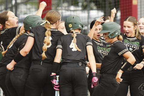 JUNO RYAN is greeted at home plate after hitting Central City’s first home run of the season during the second inning of the Bison’s 11-1 victory over Boone Central. Photos by Jordan Coslor