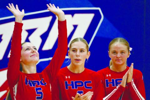 BROOKLYN WELCH blows kisses to the heavens on Thursday night during starting lineups of the Storm’s volleyball match against Nebraska Christian. Joining Welch in the lineup are Bailey Gress and Taya Hans. Photos by Michael Happ