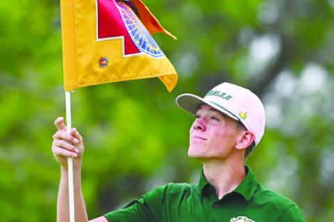 KARTER NEGUS replaces the flag on the seventh green at Indianhead Golf Club last week.