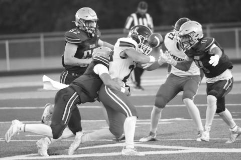 QUINN JENSEN and Broc Rathbone combine for a tackle. Jensen ripped the ball loose on the tackle, forcing a fumble on the first Adams Central drive of the game. Photos by Michael Happ