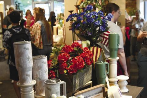 CUSTOMERS BROWSE the variety of items displayed for sale at Flourish Floral Co. in downtown Central City during the business’s open house and grand opening event earlier this year. Photos by Jordan Coslor