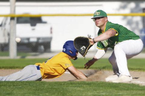 PRESTON BURBACH attempts to tag out a Kearney Jerseys baserunner at first base.