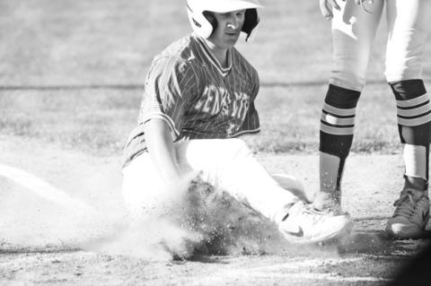 ERIK BLOMSTEDT slides safely across home plate in the fifth inning of Central City’s game with Centura last Thursday at Kernel Field.