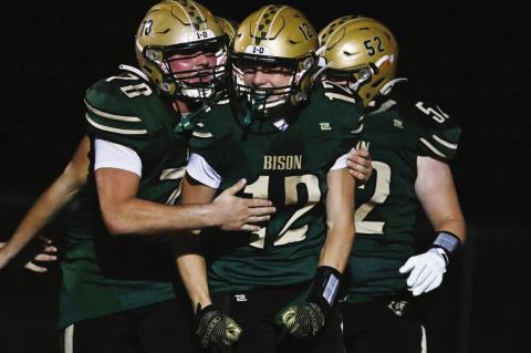 THE CENTRAL CITY BISON players Parker Santin, Jaic Rathbone, and Erik Blomstedt celebrate a Rathbone touchdown during Central City’s win over the Wayne Blue Devils last Friday evening at Preferred Popcorn Field. Photo by Michael Happ
