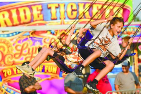 THE D.C. LYNCH SHOWS carnival was a big draw on the midway on Monday night during the Merrick County Fair. Above, Drew Friedrichsen was one of the many kids that enjoyed the rides at the fair. Photo by Jordan Coslor