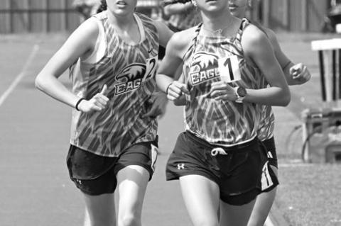 GRACE NOKELBY (right) leads the pack in the 3200-meter run at last week’s C-6 District Meet at Boone Central.