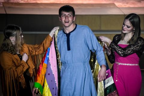 Narrator Adeline Davenport (left) helps place Joseph’s Technicolor dreamcoat on Brock Olivo (center) with the help of Katelynn Blomstedt (right). (R-N Photos and Story by Ryan Dettman)
