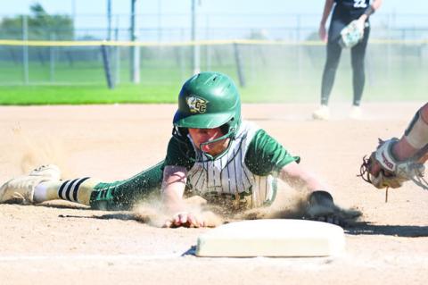 QUINNLEY BURBACH slides into third base in the fourth inning of Central City’s elimination game with Hastings St. Cecilia in the C-4 District Final at the Smith Softball Complex last week. Photos by Michael Happ