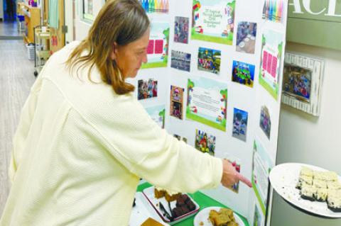 MERRICK COUNTY CHILD DEVELOPMENT CENTER Director Amy Kucera shows off some of the items highlighted during the center’s open house. Photo by Michael Happ