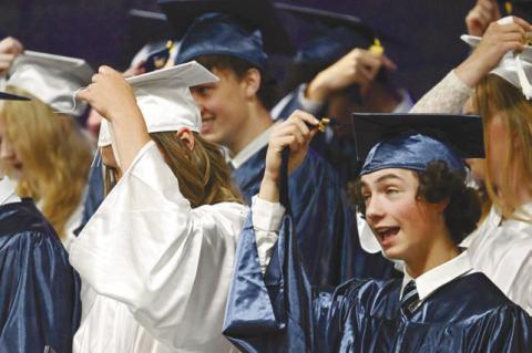 MEMBERS of the Nebraska Christian Class of 2026, including Sheridan Falk and David Carlson, turn their tassels during last week’s graduation ceremony. Twenty-six students received diplomas last Saturday. Photo by Michael Happ