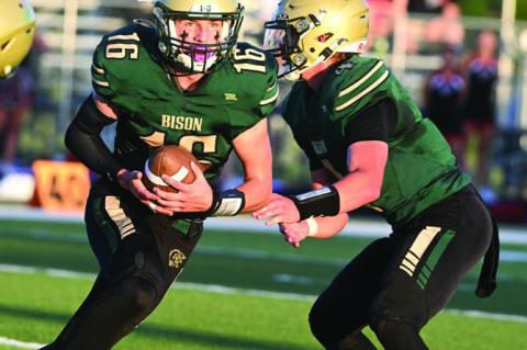 NATE BANDT takes a hand off from quarterback Quinn Jensen in Central City’s 41-7 Homecoming win over Douglas County West. Photos by Michael Happ