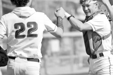 QUINN JENSEN (right)) welcomes teammate Colbyn Peters to the field ahead of Central City/Centura’s first round game with St. Paul/Palmer.