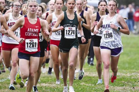 AMELIA BUHLKE works towards the front of the pack at the start of the District C-4 meet in Aurora last Wednesday. Buhlke would go on to win the race in 18:47.20. Photos by Michael Happ